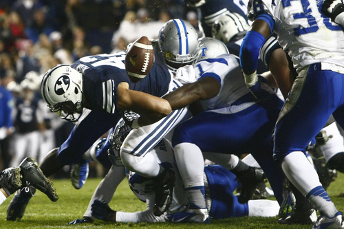 Chris Detrick  |  The Salt Lake Tribune
Brigham Young Cougars running back Michael Alisa (42) fumbles the ball at the goal line during the first half of the game at LaVell Edwards Stadium Friday September 27, 2013. BYU is winning the game 23-10 at halftime.